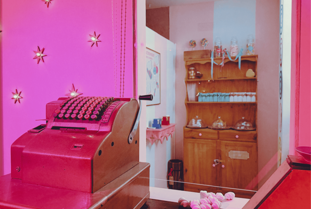 Pink vintage counter and shelves in a themed Trapt Melbourne room.
