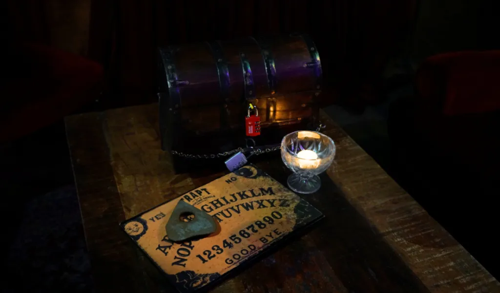Barrel, candle and ouija board props arranged on a table at Trapt Melbourne.